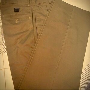 Calvin Klein men’s tan sport khaki pants with small pleats in front.